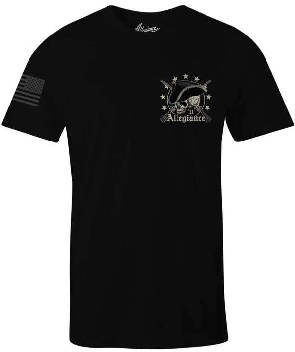 Front of Revolution Tee in black featuring small colonial skull and flintlock rifle chest graphic with American flag sleeve print.